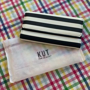 Black and white striped wallet in storage bag